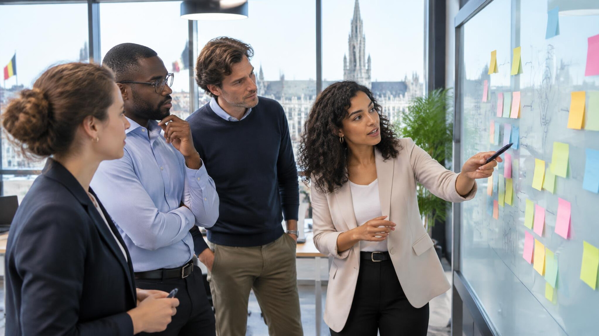 Team reviewing strategy notes on a glass board